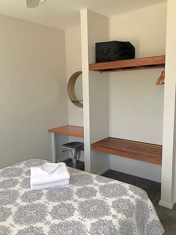 Hanging, shelve and small desk area with chair in each bedroom