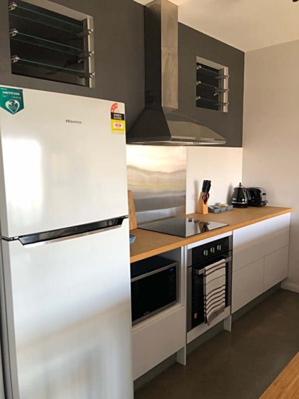 Kitchen with built in oven, microwave & hot plates